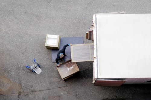 Specialist movers loading a grand piano into a vehicle