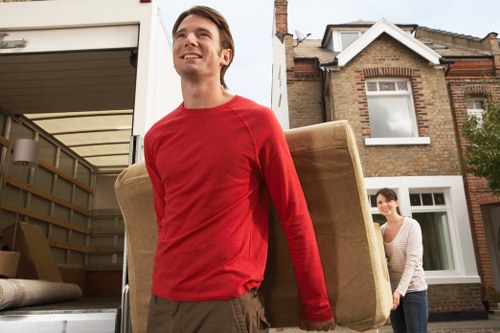 Professional movers loading furniture into a van in Brompton
