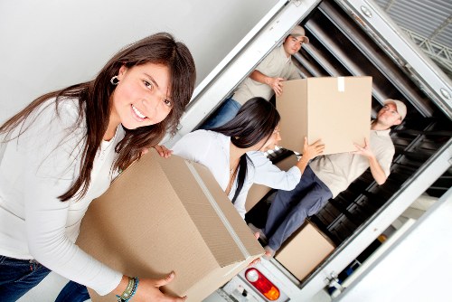 Removalists navigating a suburban Brompton property during moving day
